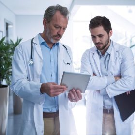 doctors-having-discussion-over-digital-tablet-in-c-2021-08-28-22-13-08-utc-Custom-qj0aappq5weq717ob77ool7rdhyl002xwgipbfq9pi